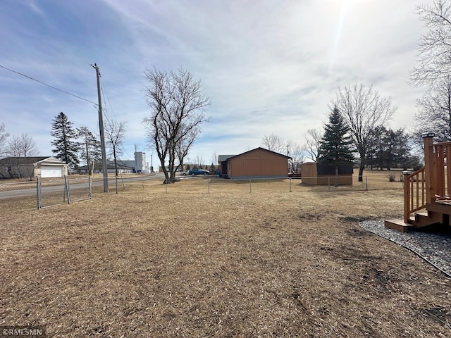 view of yard with an outbuilding and fence