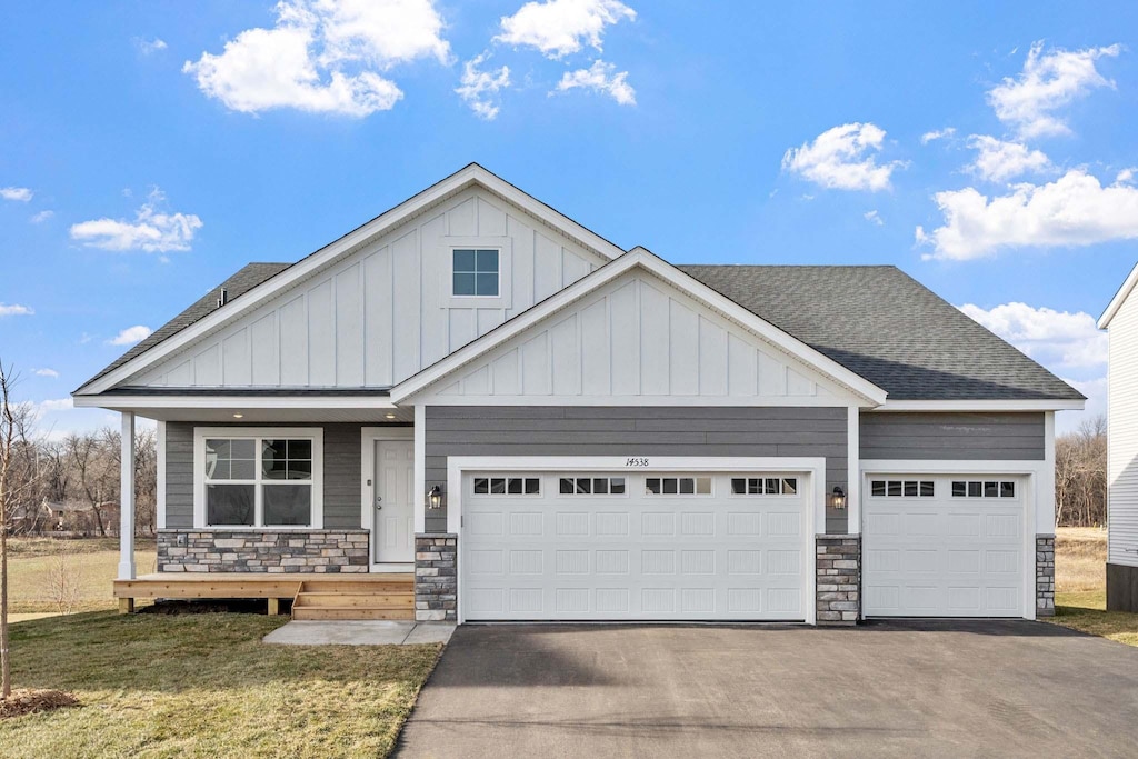 craftsman-style house featuring a front yard and a garage