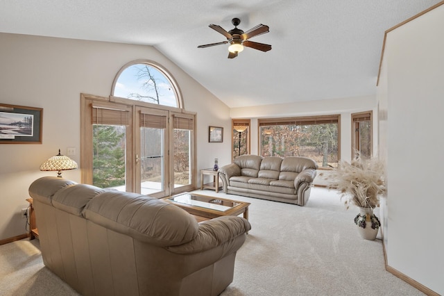 living room featuring a ceiling fan, carpet flooring, high vaulted ceiling, and baseboards