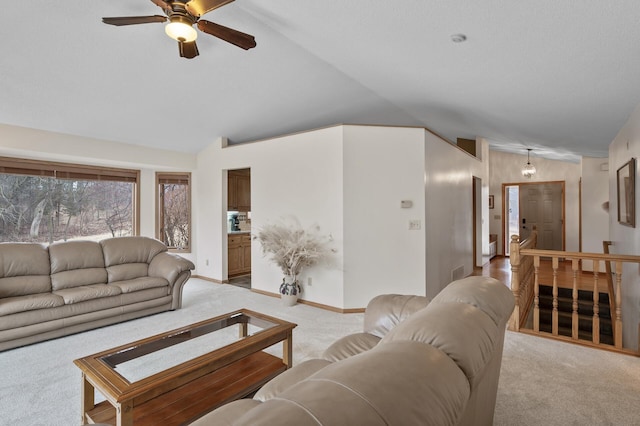 living area with visible vents, baseboards, a ceiling fan, light colored carpet, and lofted ceiling