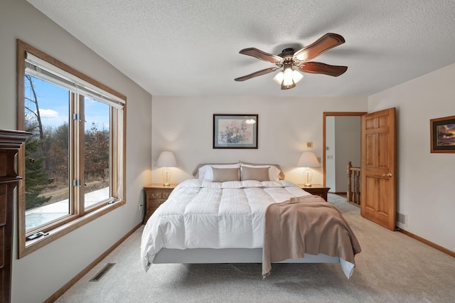 bedroom featuring multiple windows, visible vents, and light colored carpet