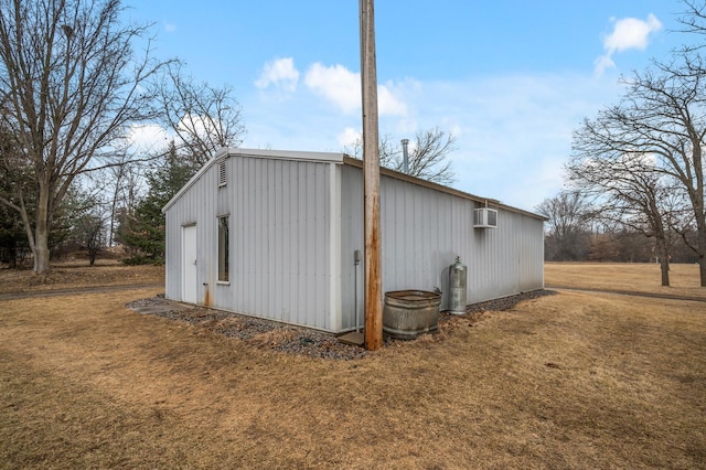 view of outdoor structure featuring an outbuilding and a wall mounted air conditioner