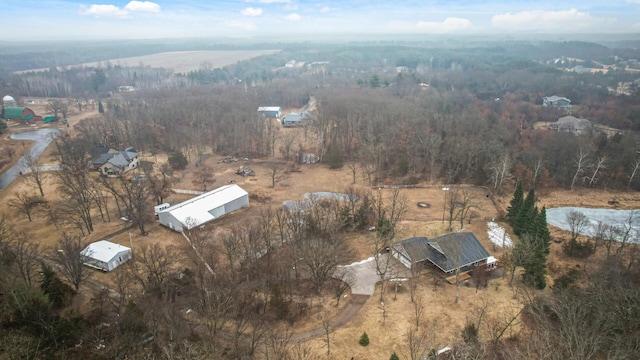 birds eye view of property with a forest view