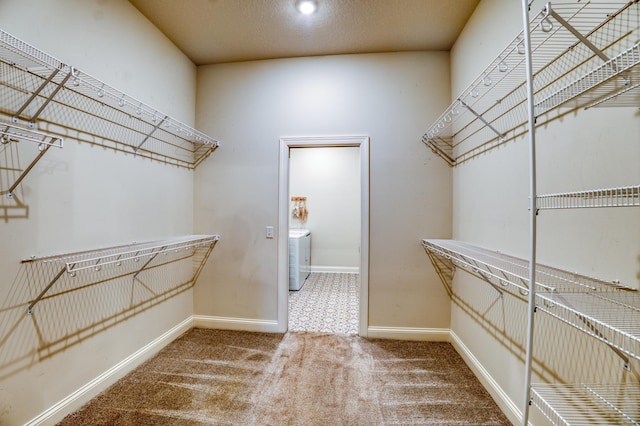 walk in closet featuring washer / clothes dryer and carpet floors