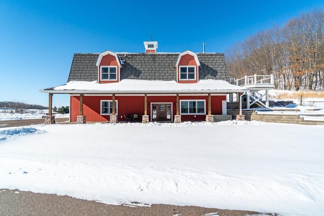 view of snow covered back of property