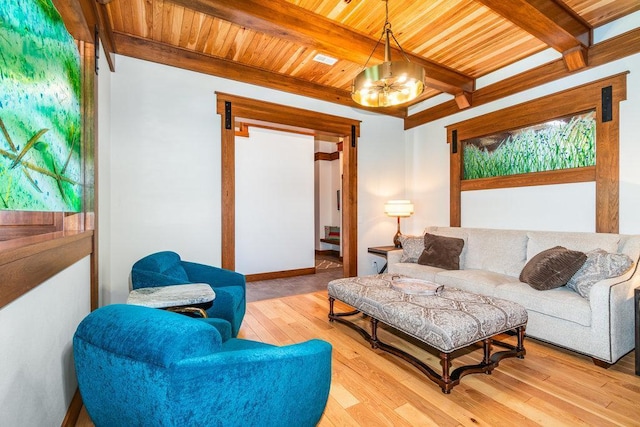 living room with wood ceiling, a notable chandelier, light wood-style flooring, and beam ceiling