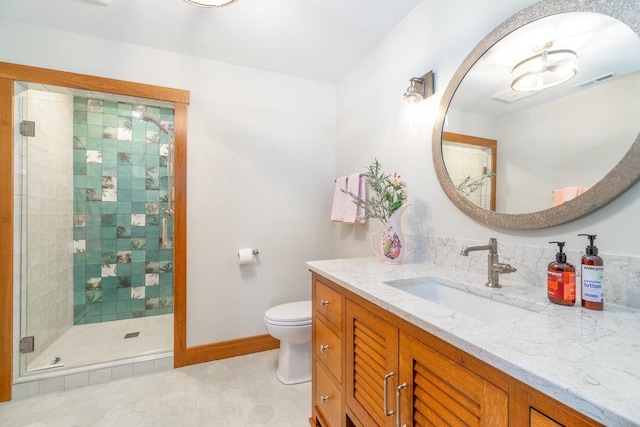 bathroom featuring a stall shower, baseboards, visible vents, toilet, and vanity