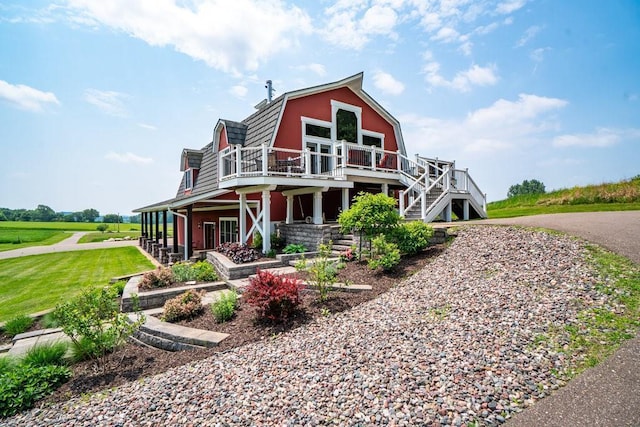 N7900 County Road J, Sherman Twp, WI 54751 - view of front of property with stairway, a wooden deck, and a gambrel roof