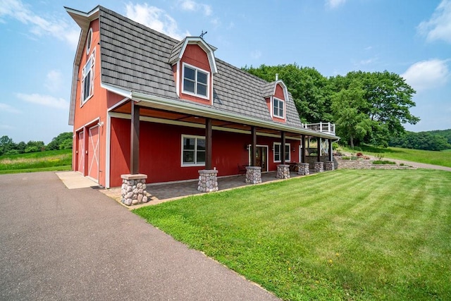 N7900 County Road J, Sherman Twp, WI 54751 - view of front of property featuring a gambrel roof, a front lawn, a garage, and asphalt driveway