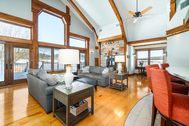 N7900 County Road J, Sherman Twp, WI 54751 - living room with ceiling fan, high vaulted ceiling, beamed ceiling, light wood-style floors, and french doors