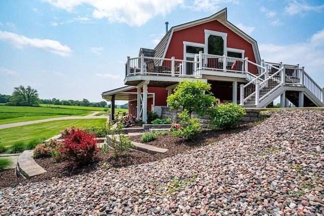 N7900 County Road J, Sherman Twp, WI 54751 - view of front of home with a wooden deck, stairs, and a gambrel roof