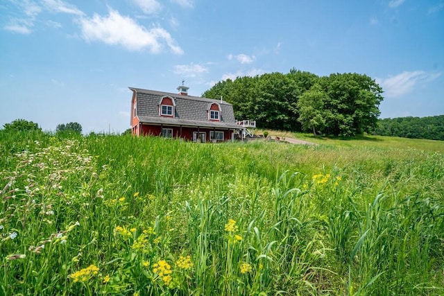 N7900 County Road J, Sherman Twp, WI 54751 - view of front of house featuring a barn, a chimney, and an outbuilding