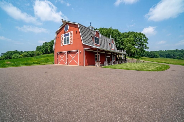 N7900 County Road J, Sherman Twp, WI 54751 - view of front of property with a barn, a gambrel roof, driveway, an outbuilding, and a front lawn