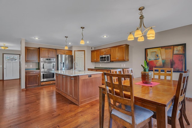 dining area featuring recessed lighting, dark wood-type flooring, and an inviting chandelier