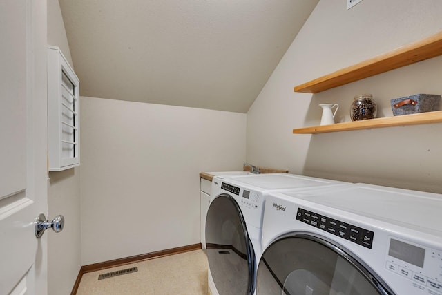 clothes washing area with visible vents, independent washer and dryer, and baseboards