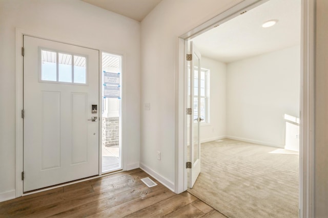 foyer entrance with hardwood / wood-style floors