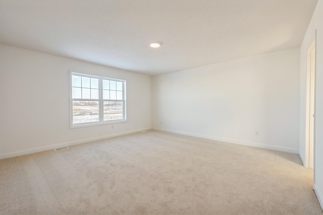 spare room with light colored carpet