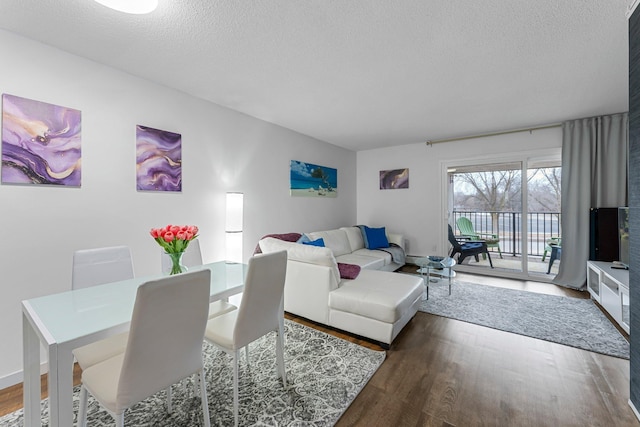 living area with a textured ceiling and wood finished floors