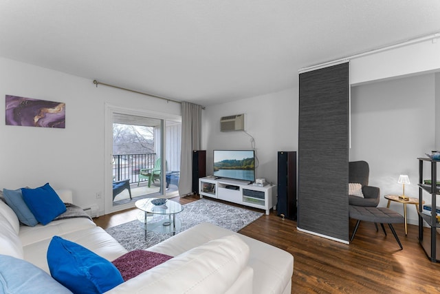 living area featuring a wall unit AC, baseboard heating, and wood finished floors