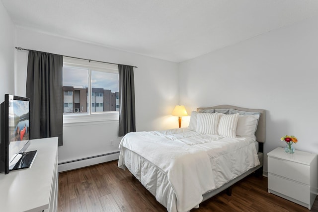 bedroom with dark wood-style floors and a baseboard radiator