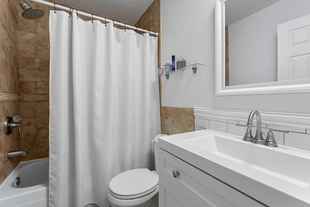 full bathroom with shower / bath combo, tile walls, toilet, and a textured ceiling