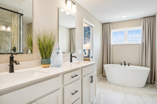 full bath with double vanity, a soaking tub, marble finish floor, and a sink