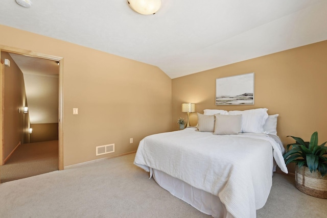 bedroom with light carpet and vaulted ceiling