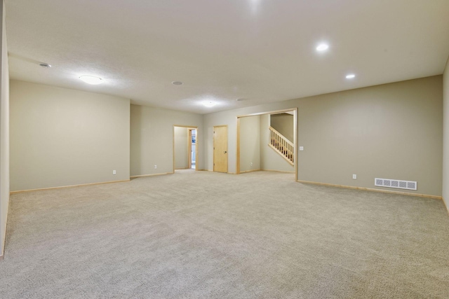 spare room featuring light colored carpet