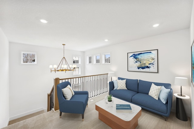 carpeted living area with recessed lighting, a notable chandelier, and baseboards