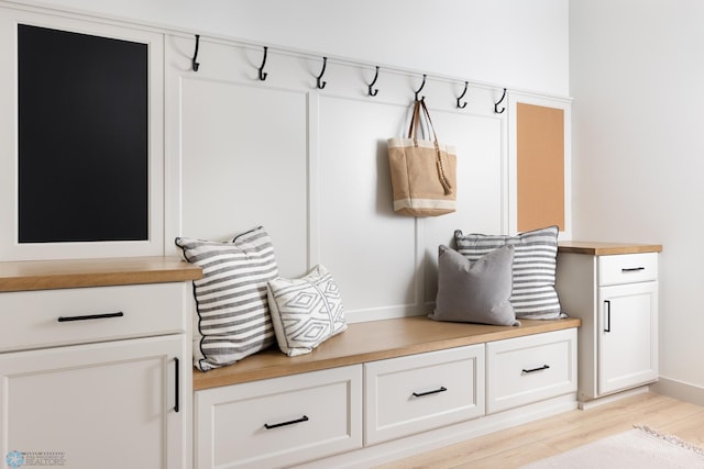 mudroom with light hardwood / wood-style floors