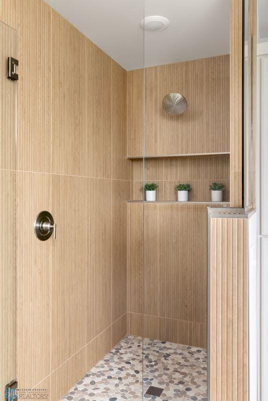 bathroom with a tile shower