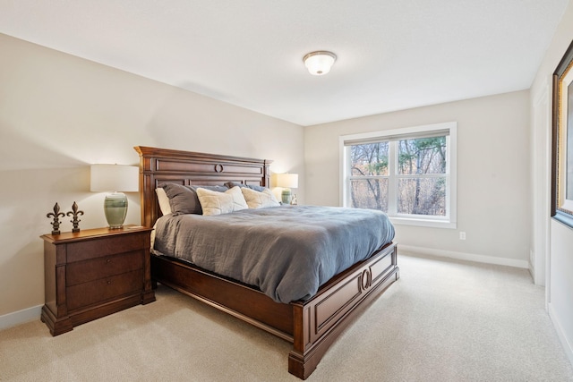 bedroom featuring baseboards and light colored carpet