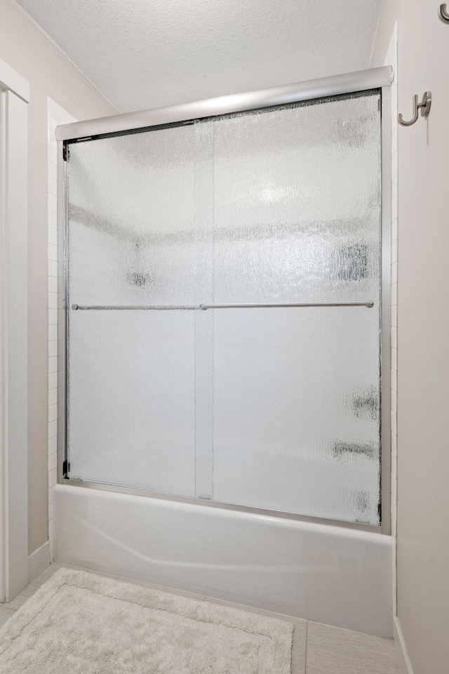 full bathroom featuring shower / bath combination with glass door