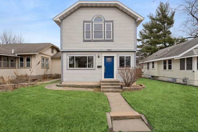 view of front facade with entry steps and a front yard