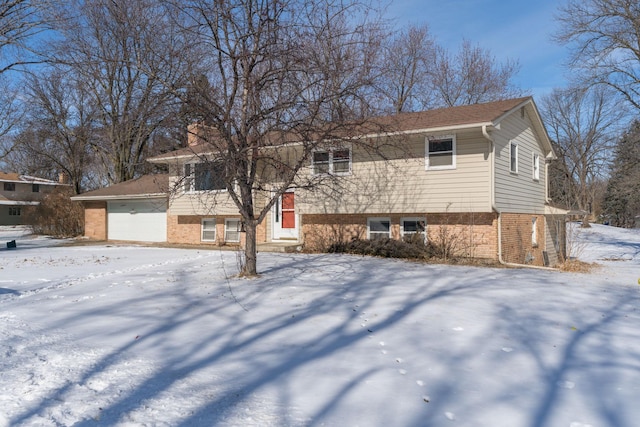 view of front of house with a garage and brick siding