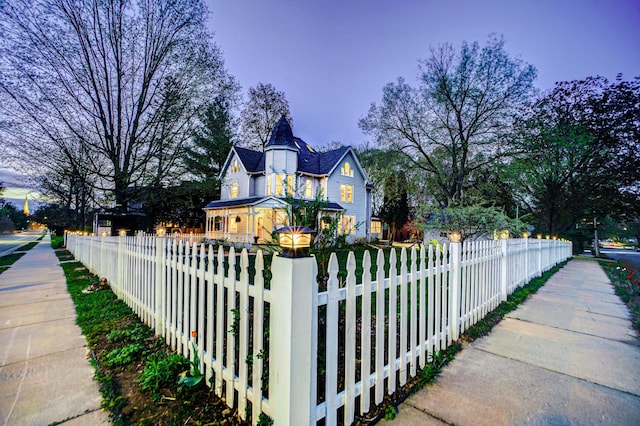 view of side of home with a fenced front yard