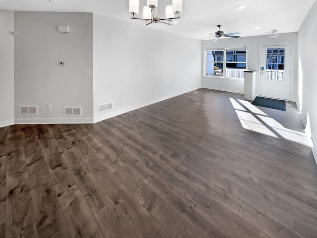 unfurnished living room featuring ceiling fan with notable chandelier and dark wood-type flooring