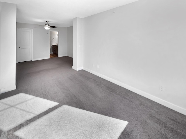 carpeted spare room featuring ceiling fan