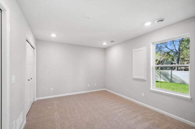 empty room featuring recessed lighting, carpet, visible vents, and baseboards