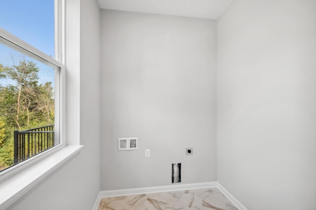 clothes washing area with hookup for a washing machine, marble finish floor, hookup for an electric dryer, and baseboards