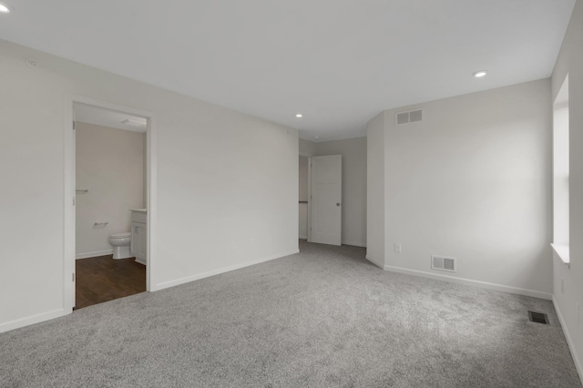 carpeted empty room featuring baseboards, visible vents, and recessed lighting