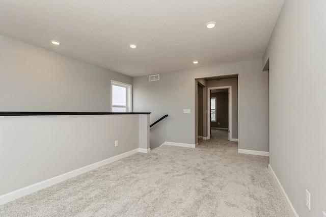 unfurnished room with light carpet