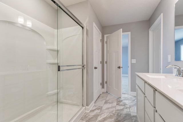 bathroom with vanity and a shower with shower door