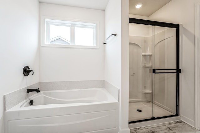 bathroom with marble finish floor, a shower stall, and a bath