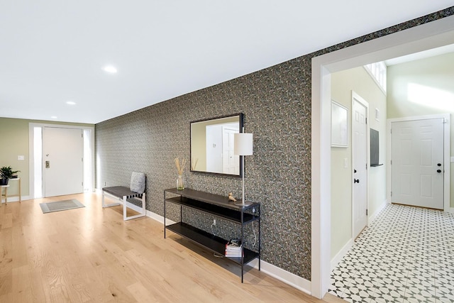 hall with baseboards, recessed lighting, wood finished floors, and wallpapered walls