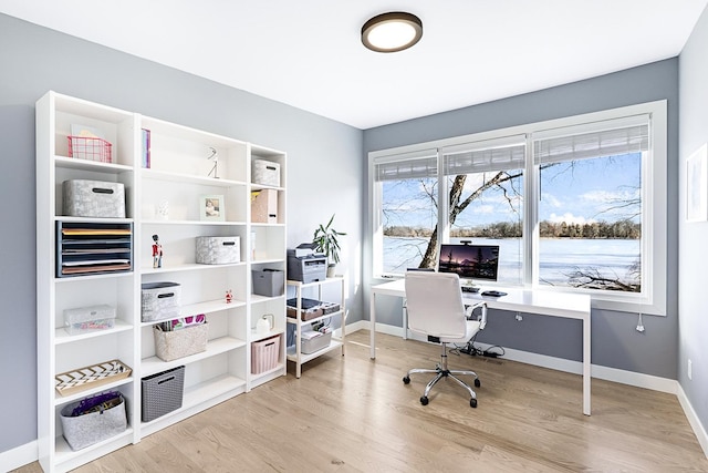 office space with light wood-style flooring and baseboards