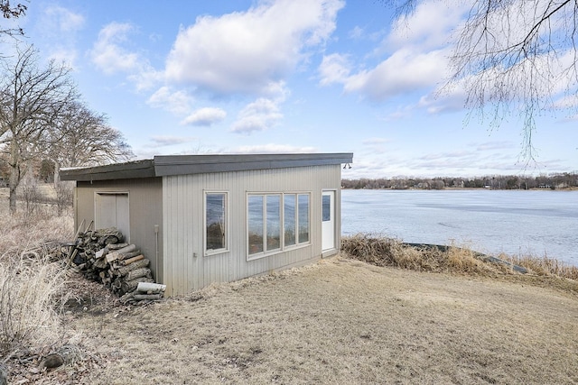 view of outdoor structure featuring a water view and an outdoor structure