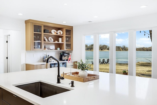 10 Shore Rd, North Oaks, MN 55127 - kitchen with a sink, light countertops, recessed lighting, glass insert cabinets, and a water view