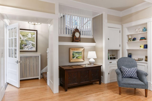 4943 Dupont Ave S, Minneapolis, MN 55419 - sitting room with radiator heating unit, light wood-type flooring, a chandelier, crown molding, and built in shelves