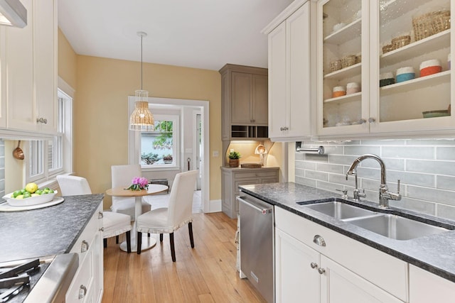 4943 Dupont Ave S, Minneapolis, MN 55419 - kitchen with dishwasher, light wood-type flooring, decorative backsplash, pendant lighting, and glass insert cabinets